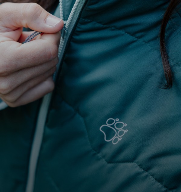 Close-up of a hand on the zip of a jacket
