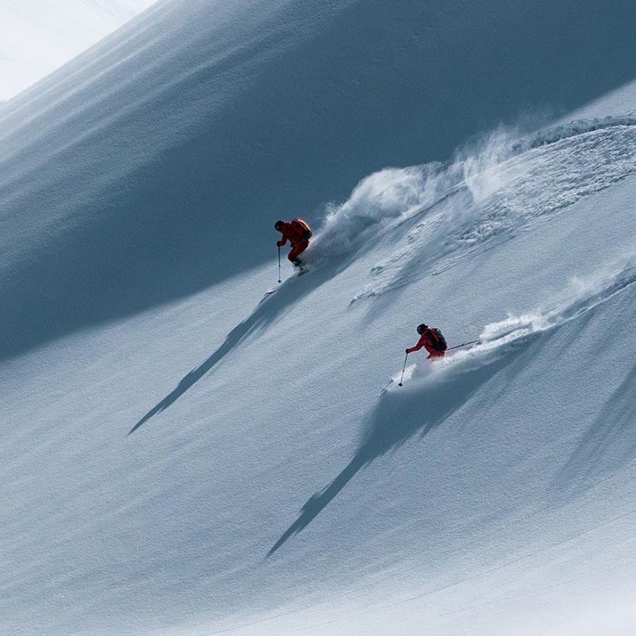 Two people skiing in the snow