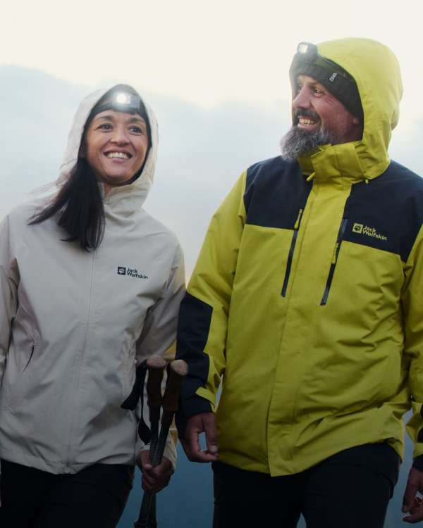 A group of four hiking and wearing jackets